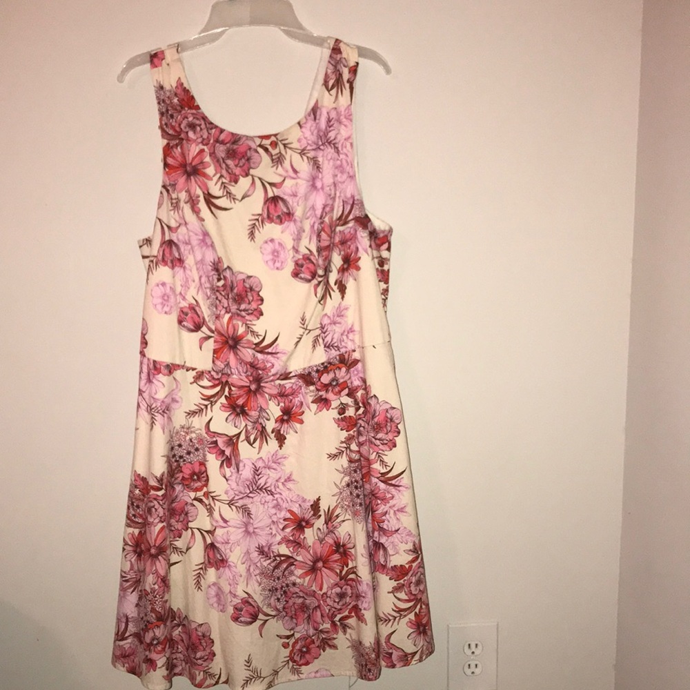 Pink,white,purple floral dress.Button and a zipper.It’s breezy.A layer of tulle.